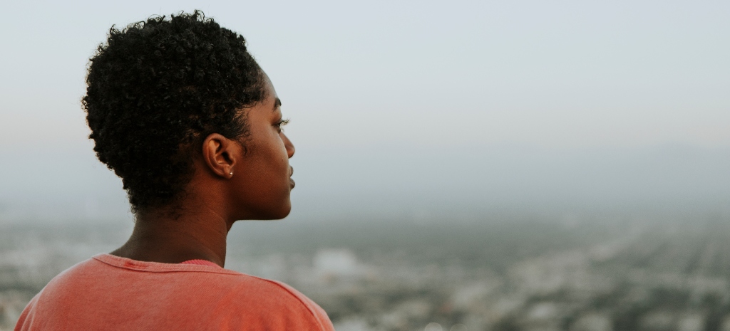Young person looking out at the ocean, representing healing from substance use disorder and destructive patterns. Our private detox in LA offers healing in a luxury setting.