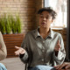 A woman sitting in a group and talking for the topic best inpatient rehab california.