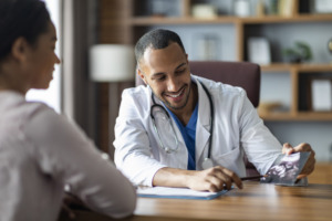 A doctor smiling while talking with a patient for the topic best alcohol addiction treatment centers.