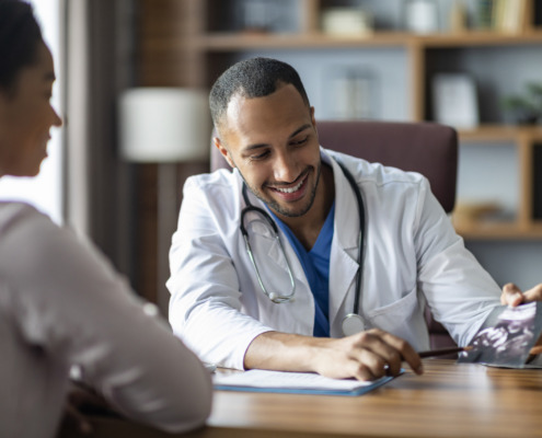 A doctor smiling while talking with a patient for the topic best alcohol addiction treatment centers.