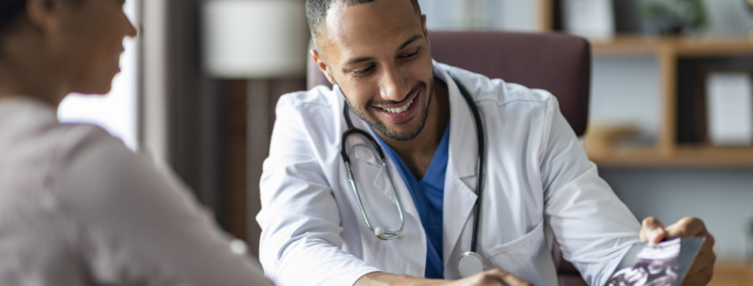 A doctor smiling while talking with a patient for the topic best alcohol addiction treatment centers.