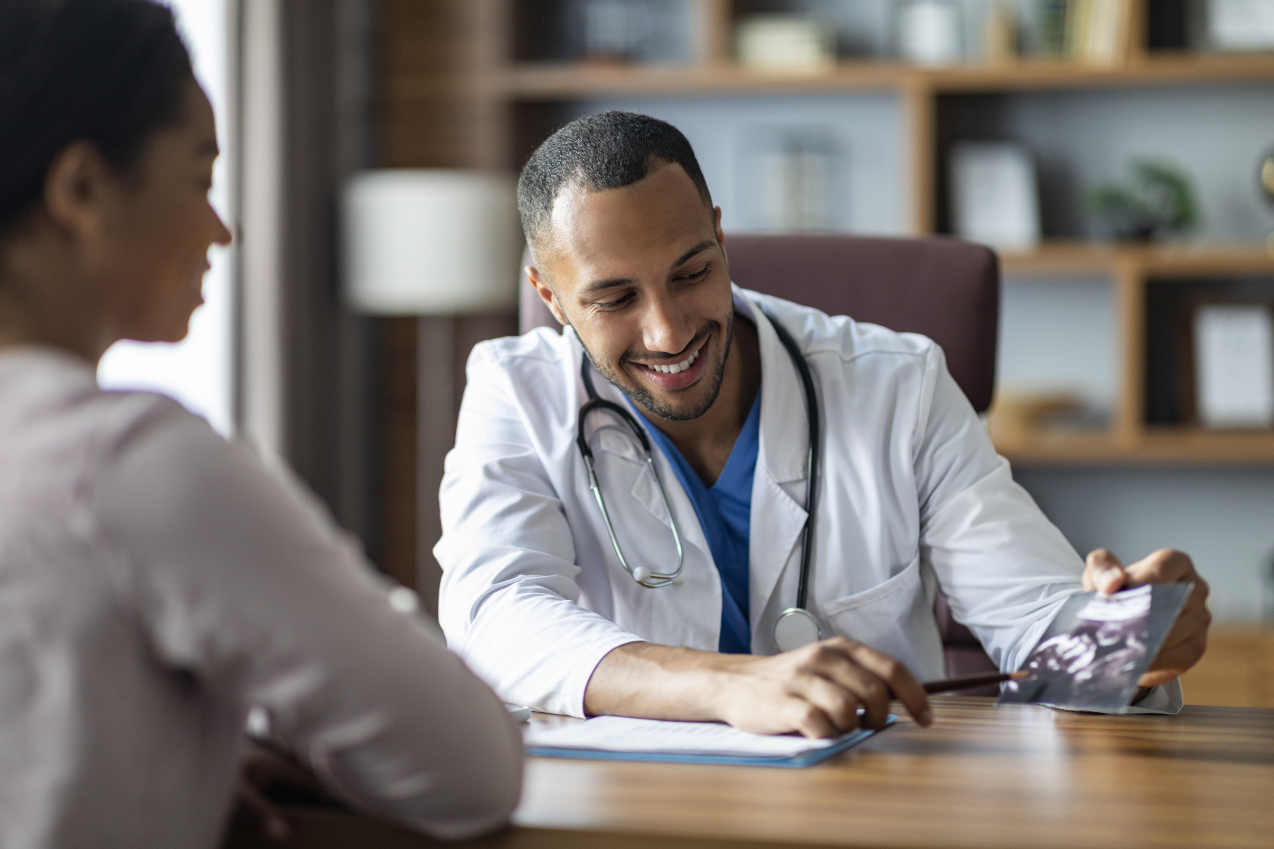 A doctor smiling while talking with a patient for the topic best alcohol addiction treatment centers.