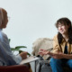 A woman smiling while talking to a therapist for the topic best dual diagnosis treatment centers.